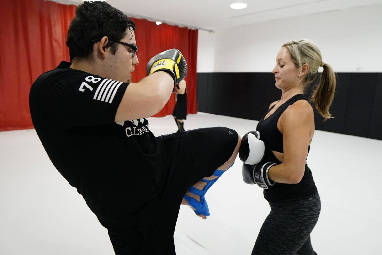 man and woman practicing muay thai kicks