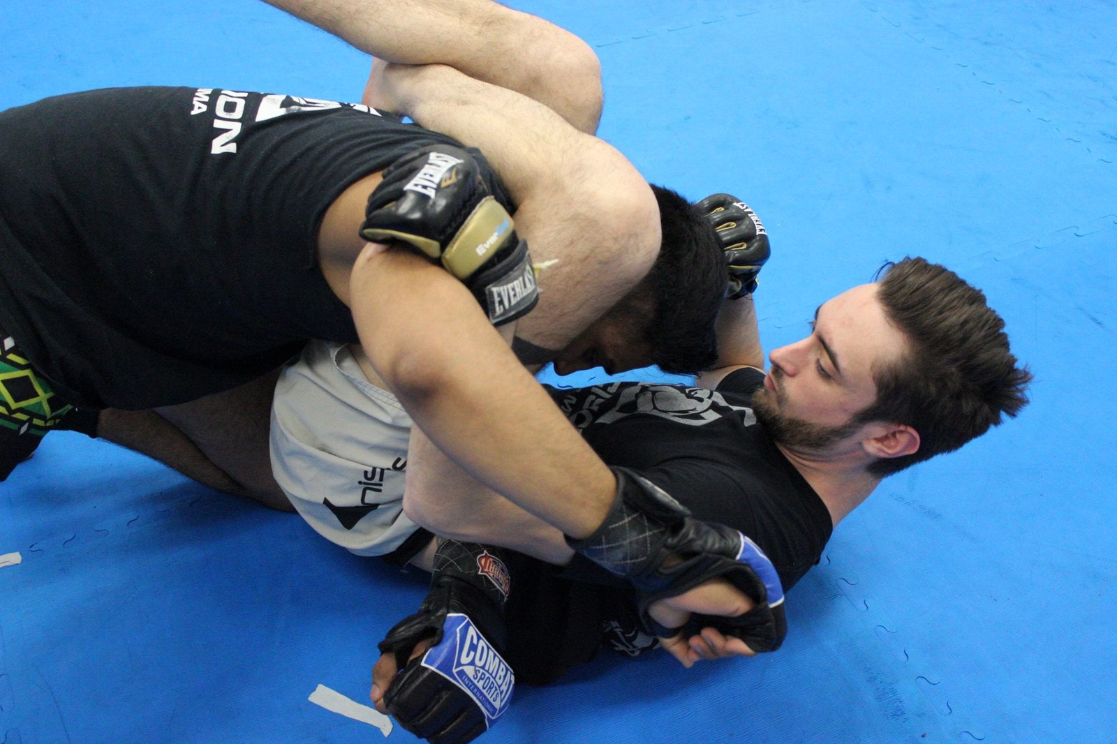 two men sparring in octagon precision