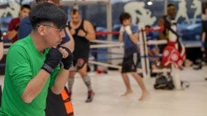 man in green shirt in fighting stance
